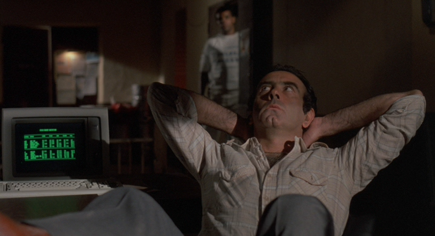 Dan Hedaya as Julian Marty Reclined at His Desk