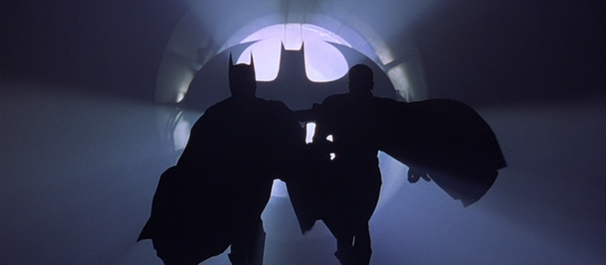 Batman and Robin's Silhouettes as They Run Toward the Camera