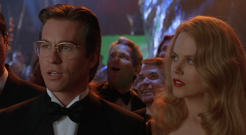 Val Kilmer as Bruce Wayne and Nicole Kidman as Chase Meridian