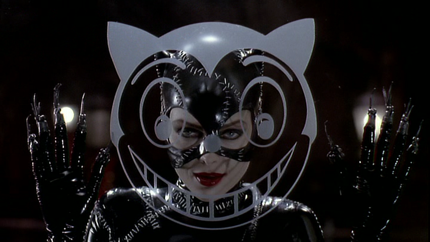 Catwoman Looks Through a Window with the Shreck Department Store Logo On It