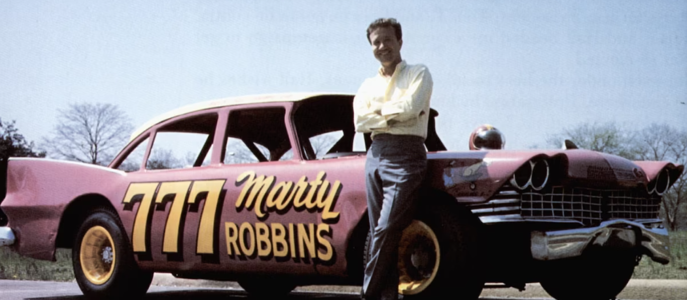 Marty Robbins Poses with His Racecar