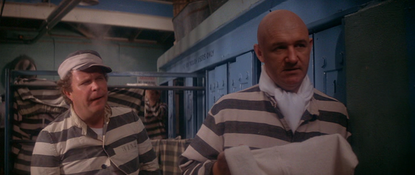 Gene Hackman as Lex Luthor and Ned Beatty as Otis
